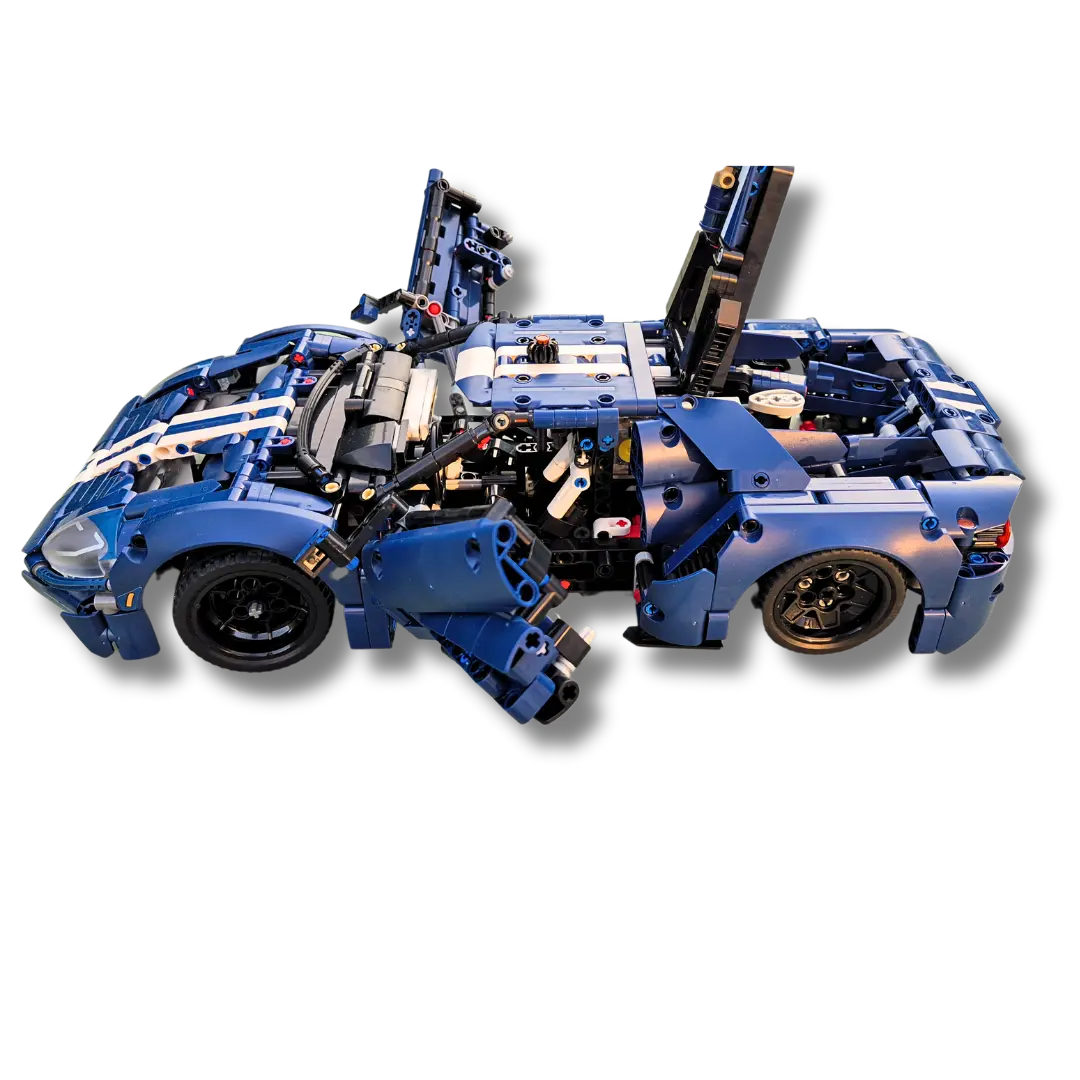 Brick-built Ford GT sports car model in blue with white racing stripes, featuring open doors, hood, and rear engine compartment, showcasing detailed internal components